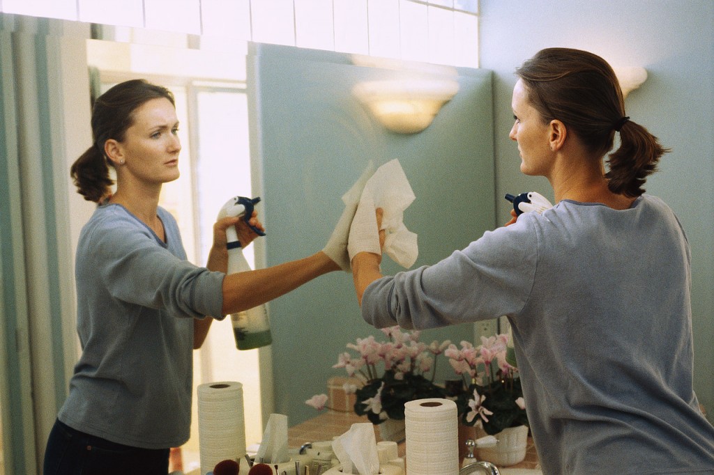 Woman Cleaning Mirror ca. 1999