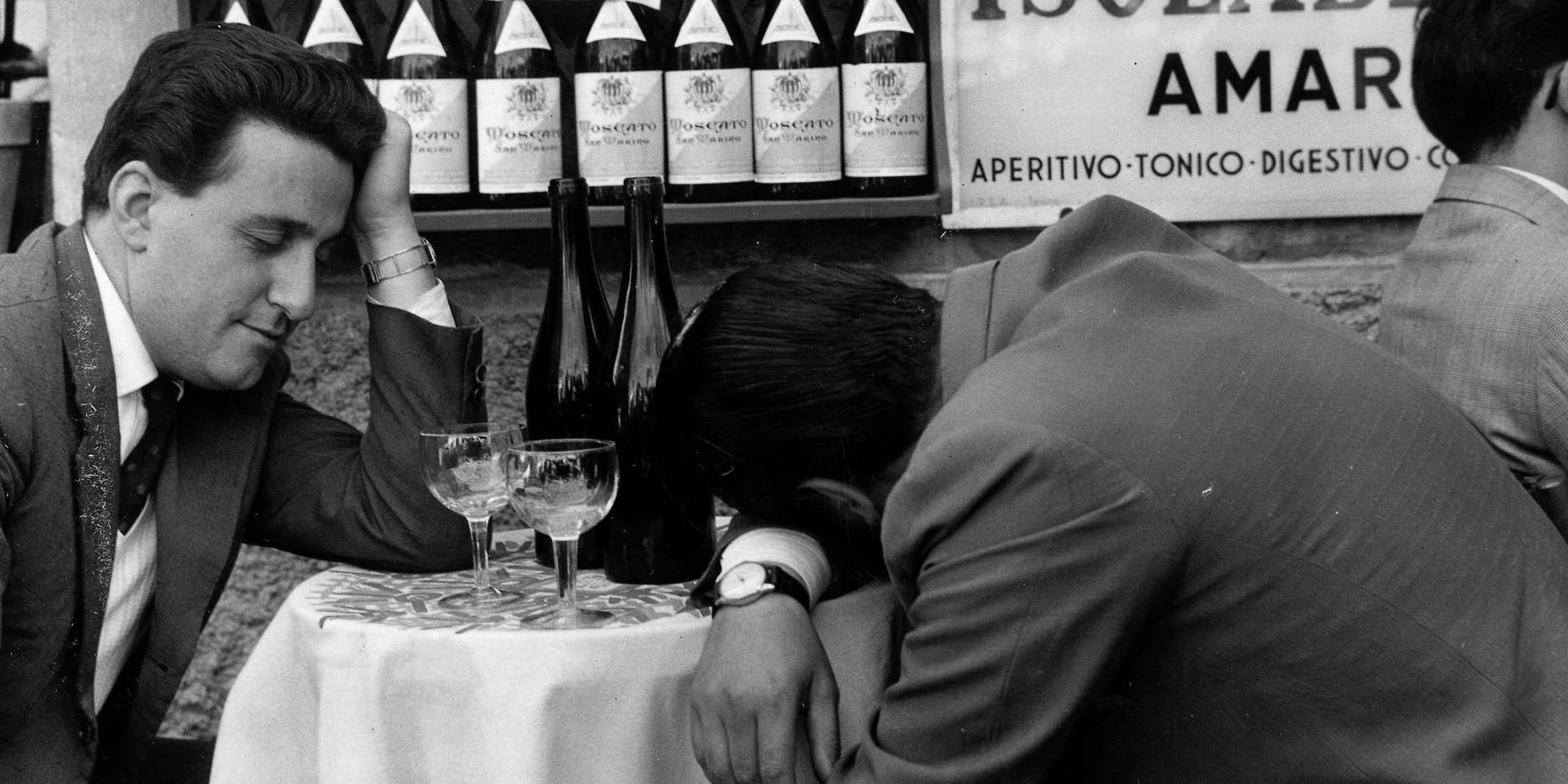 Classic Collection, Page 86, 10404106, Frascati, Italy, 23rd November 1957, Two men sit at a table, one with his head slumped on the table and the other practically asleep, with two empty bottles of wine in front of them (Photo by Popperfoto/Getty Images)